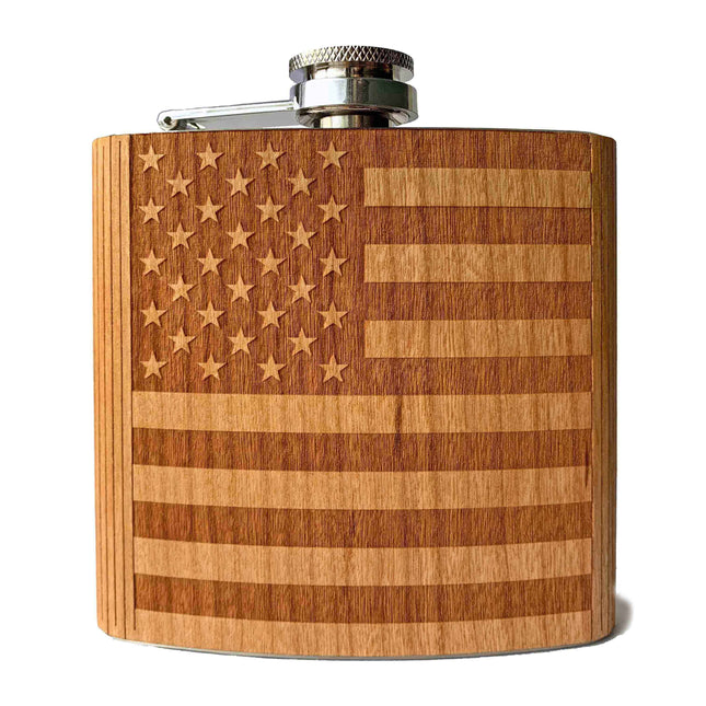 an image of a cherry wood flask, engraved with the American Flag against a white background. Product by Autumn Woods Co