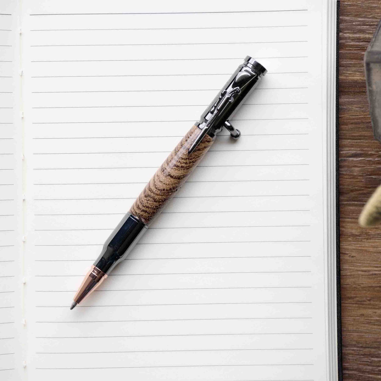 https://www.autumnwoodsco.com/cdn/shop/products/AutumnWoodsCollectiveHandmadeLatheTurnedZebraWoodBoltActionPen.jpg?v=1654799971&width=1445