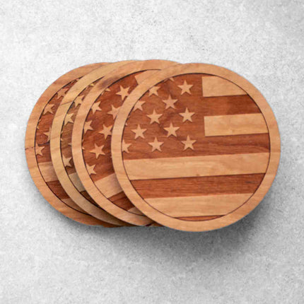 A set of 4 round cherry wood coasters with the american flag engraved on them by Autumn Woods Co